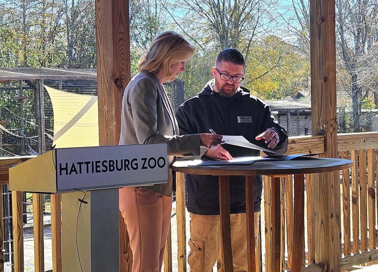 Kelly Lucas, vice president of research at the University of Southern Mississippi, and Jeremy Cumpton, director of conservation, education and wildlife at Hattiesburg, Miss., Zoo, sign a memorandum of understanding formalizing a partnership between the zoo and the university during a news conference at the zoo, Wednesday, Jan. 31, 2024.