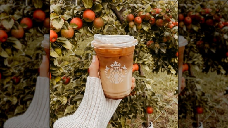 Woman holding apple crisp macchiato