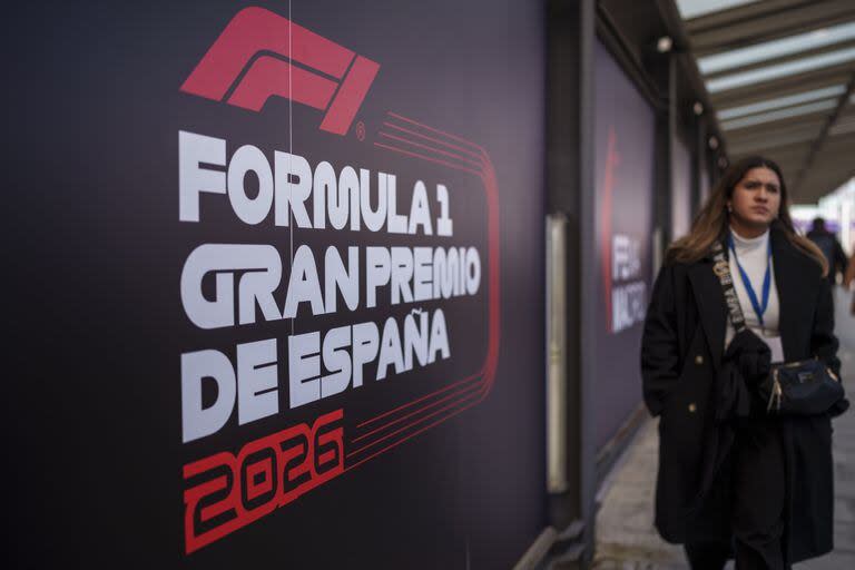 A woman walks past a banner announcing the next Formula One from 2026 at the IFEMA congress centre in Madrid, Spain, Tuesday, Jan. 23, 2024. A Madrid grand prix will join the Formula One calendar from 2026 on a track that will include street and non-street sections around the city's exhibition center. (AP Photo/Manu Fernandez)