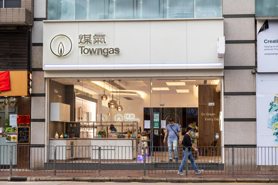 Hong Kong - March 18, 2022 : People walk past the Towngas Customer Centre in Causeway Bay, Hong Kong.
