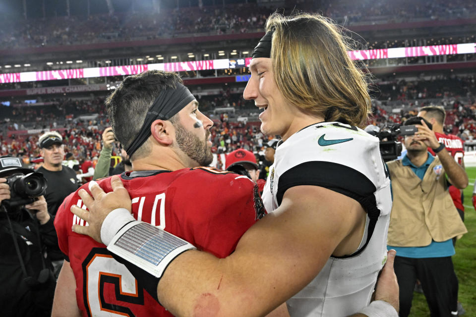 Tampa Bay Buccaneers quarterback Baker Mayfield, left, and Jacksonville Jaguars quarterback Trevor Lawrence greet each other after an NFL football game Sunday, Dec. 24, 2023, in Tampa, Fla. (AP Photo/Jason Behnken)