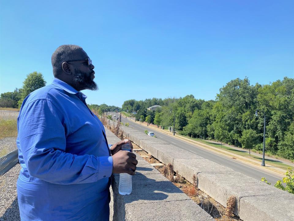 Hard Bargain Association executive director Derrick Solomon looks out over Hillsboro Road on Wednesday, June 29, 2022 while walking through the downtown Franklin property referred to as "The Hill." Via the work of local housing advocacy leaders like Solomon, The Hill is currently scheduled to become the site of 39 affordable and workforce townhomes.