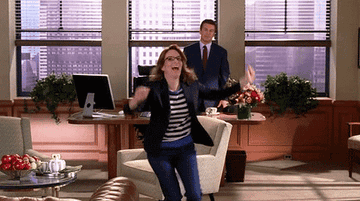 Liz Lemon running out of room with arms flailing above head