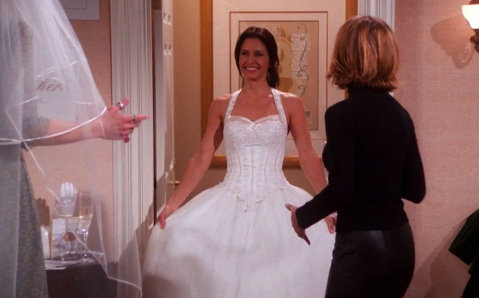 Monica wearing a ballgown with straps and a sweetheart neckline