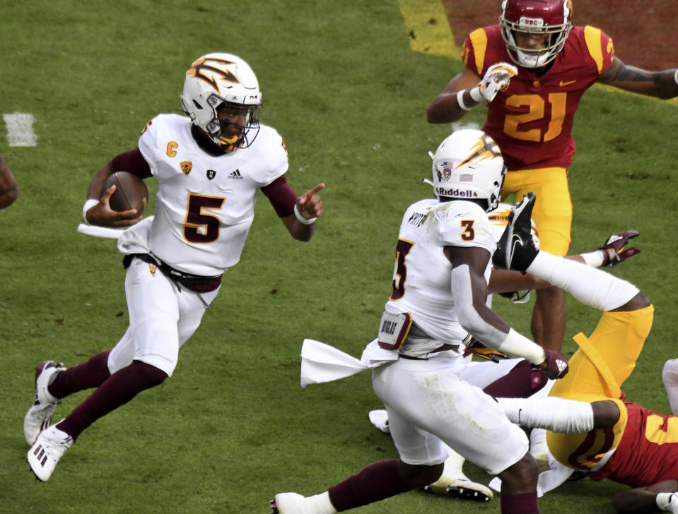 Quarterback Jayden Daniels #5 of the Arizona State Sun Devils scrambles against USC Trojans in the first half of a NCAA football game at the Los Angeles Memorial Coliseum in Los Angeles on Saturday, November 7, 2020. (Keith Birmingham/The Orange County Register via AP)