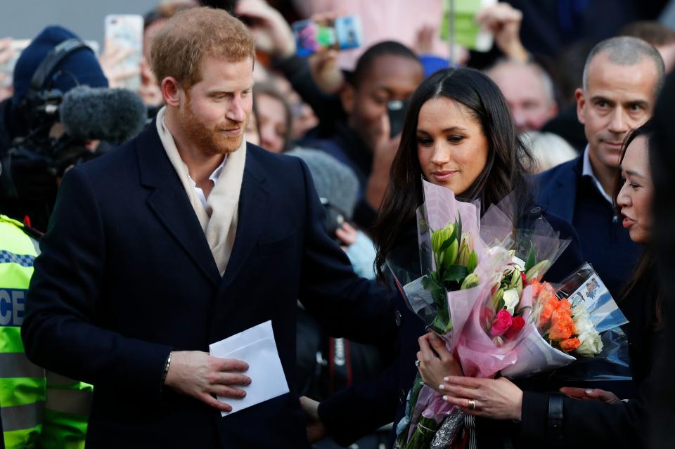 Britain's Prince Harry and his fiancee US actress Meghan Markle are greeted as they arrive to attend a Terrence Higgins Trust World AIDS Day charity fair at Nottingham Contemporary in Nottingham, central England, on December 1, 2017