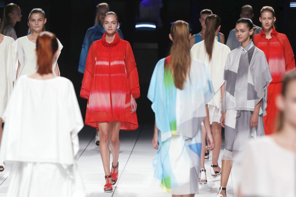 Models present creations as part of Issey Miyake's ready-to-wear Spring/Summer 2014 fashion collection, presented Friday, Sept. 27, 2013 in Paris. (AP Photo/Jacques Brinon)