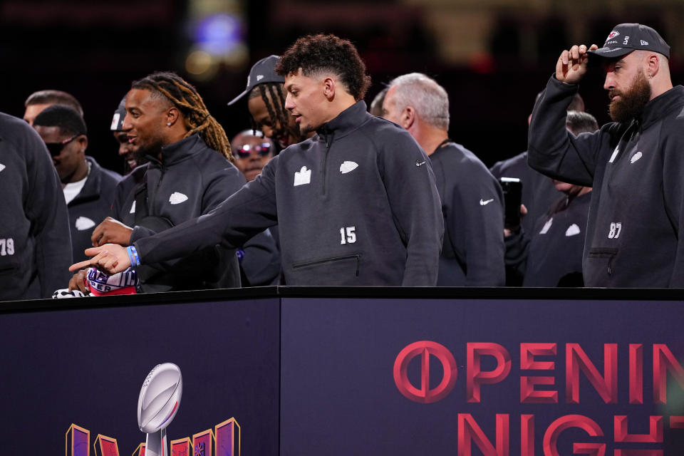 Kansas City Chiefs quarterback Patrick Mahomes and tight end Travis Kelce watch during NFL football Super Bowl 58 opening night Monday, Feb. 5, 2024, in Las Vegas. The San Francisco 49ers face the Kansas City Chiefs in Super Bowl 58 on Sunday. (AP Photo/Matt York)