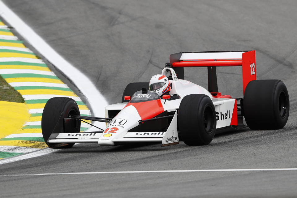 Former driver Martin Brundle steers the McLaren used by the Brazilian F1 driver Ayrton Senna in 1988, at the Interlagos racetrack in Sao Paulo, Brazil, Thursday, Nov. 14, 2019. (AP Photo/Nelson Antoine)