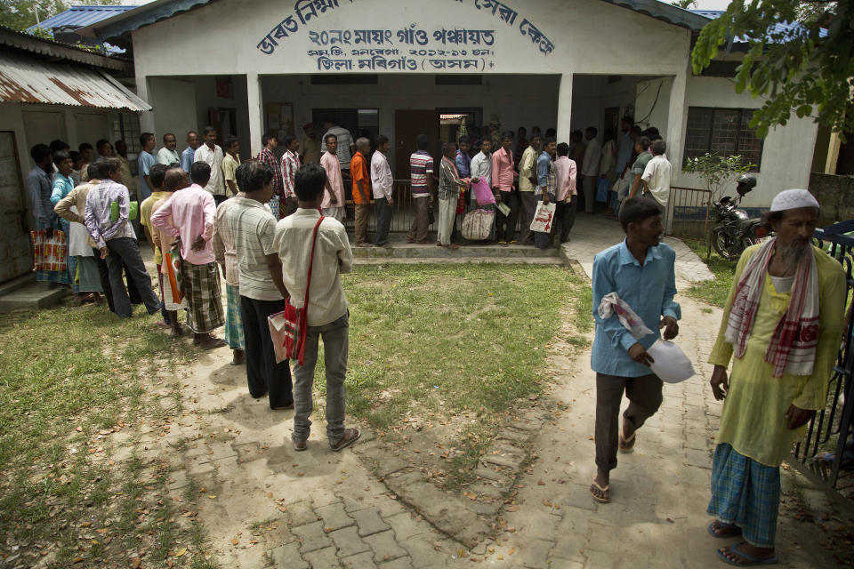 People whose names were left out in the National Register of Citizens (NRC) draft stand in a queue to collect forms to file appeals in Mayong, 45 kilometers (28 miles) east of Gauhati, India, Friday, Aug. 10, 2018. A draft list of citizens in Assam, released in July, put nearly 4 million people on edge to prove their Indian nationality. Nativist anger churns through Assam, just across the border from Bangladesh, with many believing the state is overrun with illegal migrants. (AP Photo/Anupam Nath)
