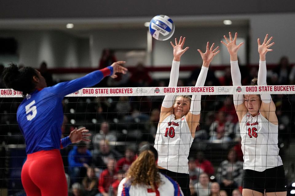 Dec 2, 2022; Columbus, Ohio, USA;  Ohio State Buckeyes Mac Podraza (10) and Adria Powell (16) block Tennessee State Tigers Celestial Miller (5) during the NCAA women's volleyball tournament first round match at the Covelli Center. Mandatory Credit: Adam Cairns-The Columbus Dispatch