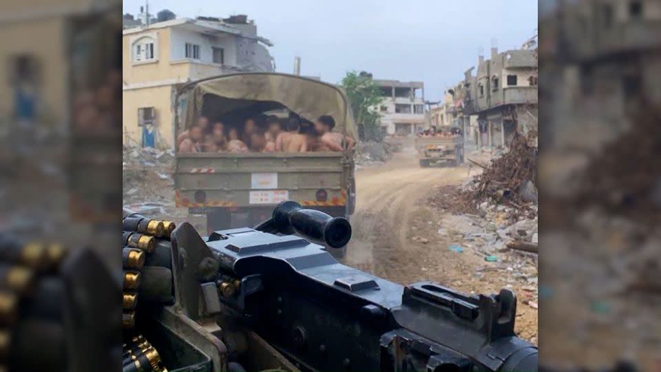 The men can be seen in the cargo bed of a military vehicle.  - Obtained by CNN