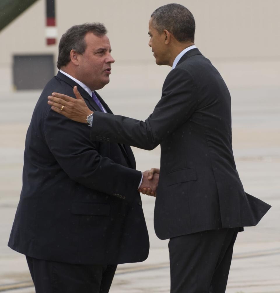 Then US President Barack Obama shakes hands with then New Jersey Governor Chris Christie (L) following Hurricane Sandy. 