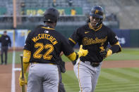 Pittsburgh Pirates' Connor Joe, right, is congratulated by Andrew McCutchen (22) after hitting a home run during the first inning of a baseball game against the Oakland Athletics in Oakland, Calif., Tuesday, April 30, 2024. (AP Photo/Jeff Chiu)