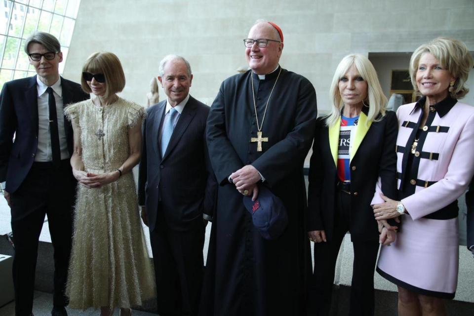 Cardinal Dolan pictured at the exhibition opening with curator Andrew Bolton, Anna Wintour, host Donatella Versace and Stephen and Christine Schwarzmann, who were honorary chairs of this year's event. (Rex Features)