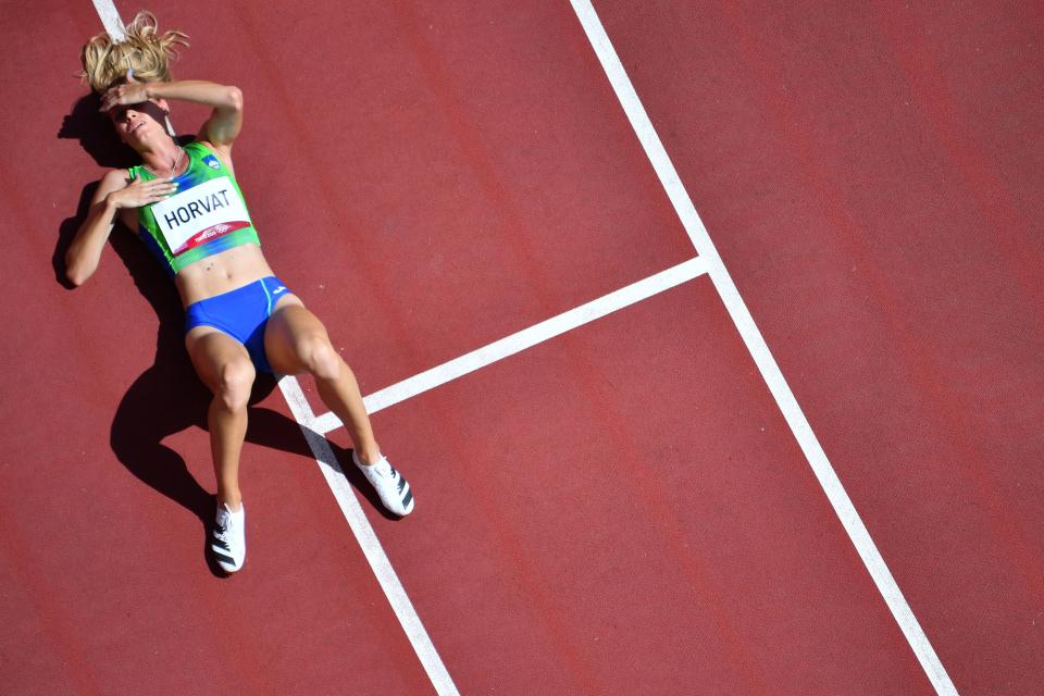 <p>An overview shows Slovenia's Anita Horvat reacting after competing in the women's 400m heats during the Tokyo 2020 Olympic Games at the Olympic Stadium in Tokyo on August 3, 2021. (Photo by Antonin THUILLIER / AFP)</p> 