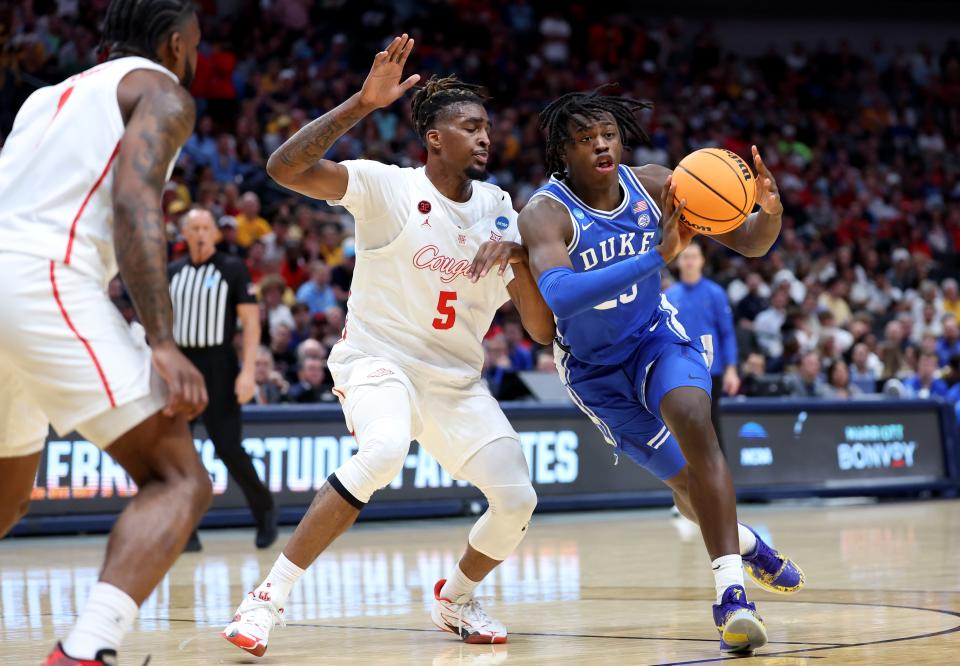 Duke forward Mark Mitchell (25) drives against Houston forward Ja'Vier Francis (5) during the first half of the semifinals of the South Regional of the 2024 NCAA men's tournament at American Airlines Center.