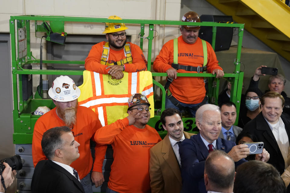 President Joe Biden takes a photo with workers after delivering remarks on his economic agenda at LIUNA Training Center, Wednesday, Feb. 8, 2023, in DeForest, Wis. (AP Photo/Patrick Semansky)