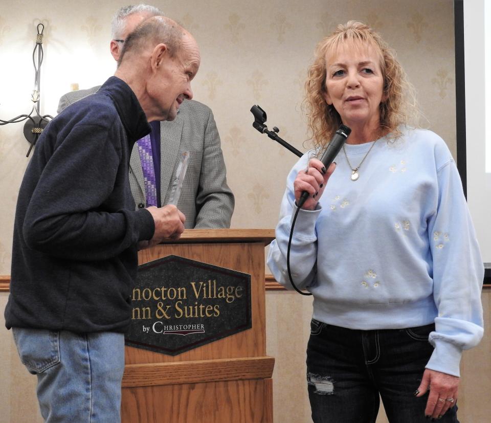 David Hahn looks at Deana Cushman as they accept the Dedication Award Wednesday at the Developmental Disabilities Awareness Month Luncheon and Coshocton Village Inn and Suites. Cushman was recognized for all she does to help Hahn to live independently and make his own decisions.