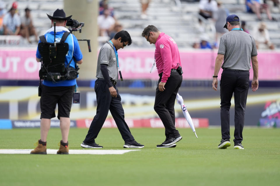 Officials inspect the field before an ICC Men's T20 World Cup cricket match between the United States and Ireland at the Central Broward Regional Park Stadium in Lauderhill, Fla., Friday, June 14, 2024. (AP Photo/Lynne Sladky)