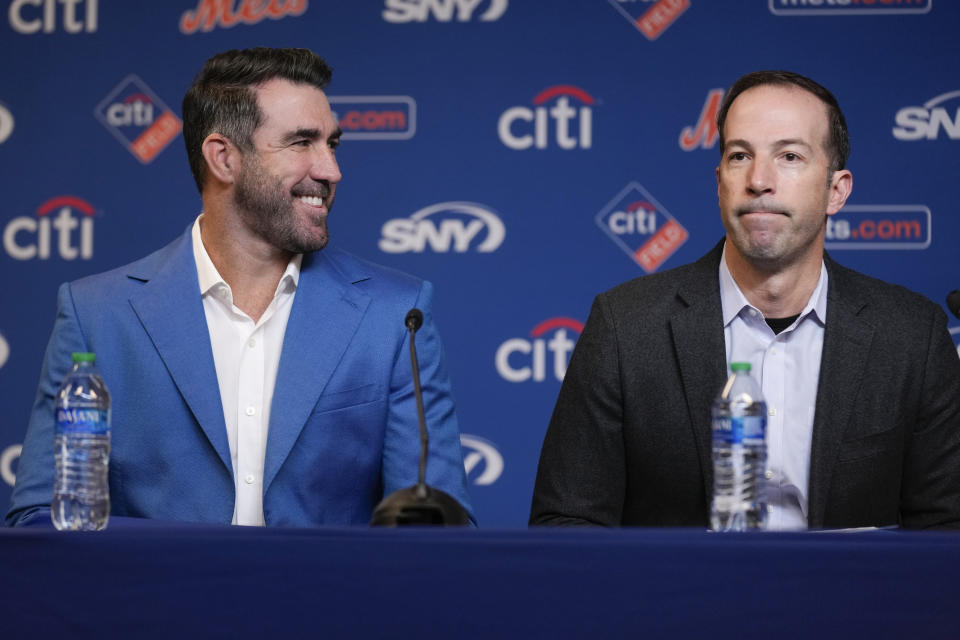 New York Mets general manager Billy Eppler, right, speaks while pitcher Justin Verlander looks on during a baseball news conference at Citi Field, Tuesday, Dec. 20, 2022, in New York. The team introduced Verlander after they agreed to a $86.7 million, two-year contract. It's part of an offseason spending spree in which the Mets have committed $476.7 million on seven free agents. (AP Photo/Seth Wenig)