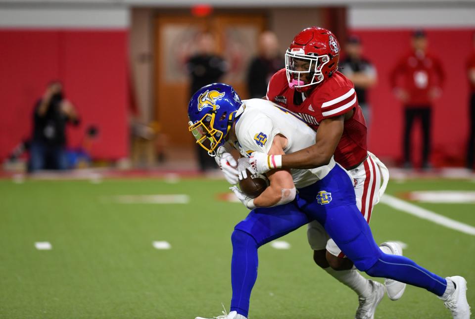 South Dakota's Teven McKelvey tackles South Dakota State's Jaxon Janke on Saturday, November 13, 2021, at the DakotaDome in Vermillion.