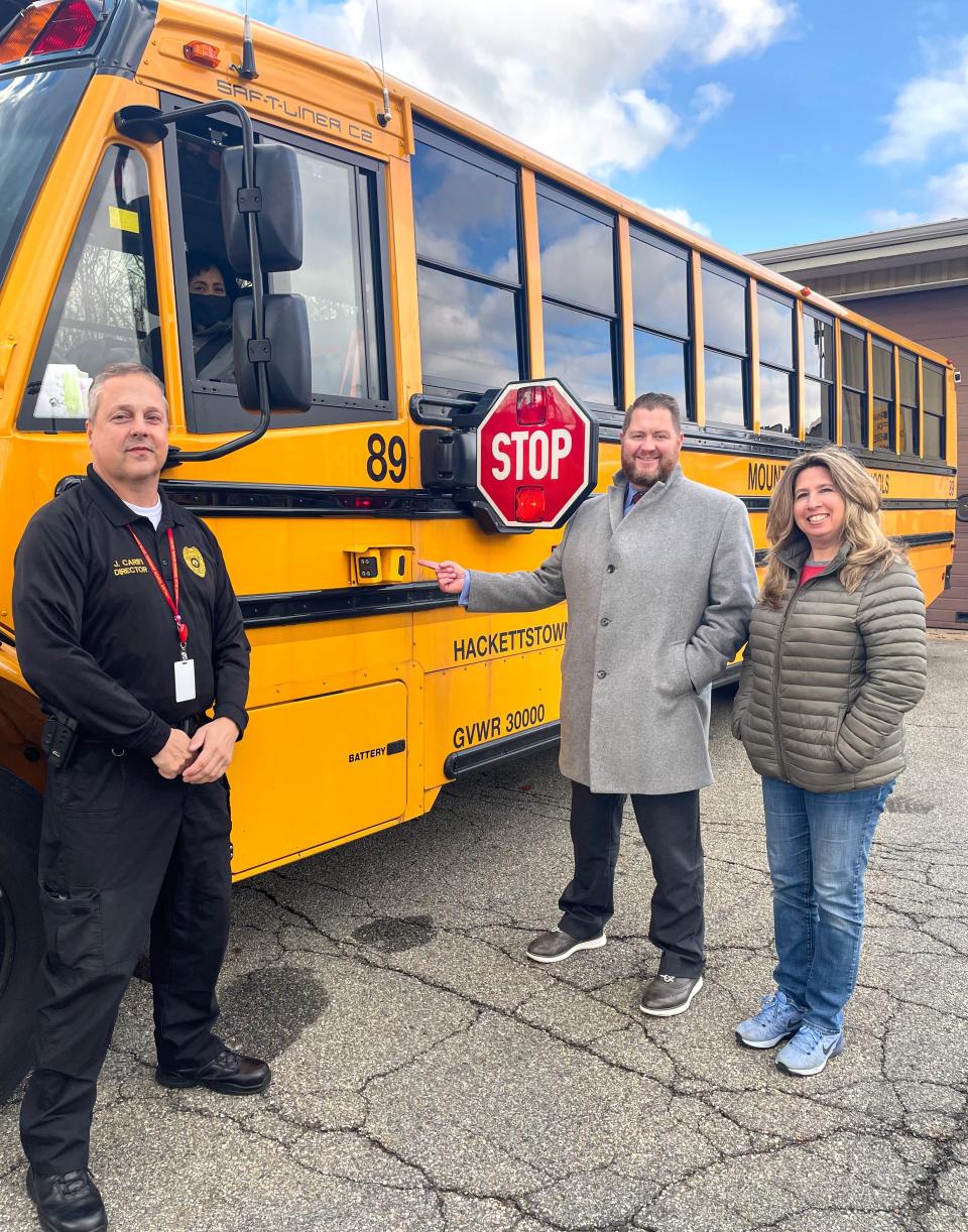 From left, Mount Olive School District James Carifi, Superintendent Robert Zywicki and Transportation Director Pamela Agnes with a district school bus outfitted with security cameras to catch motorists who pass it in violation of the law.