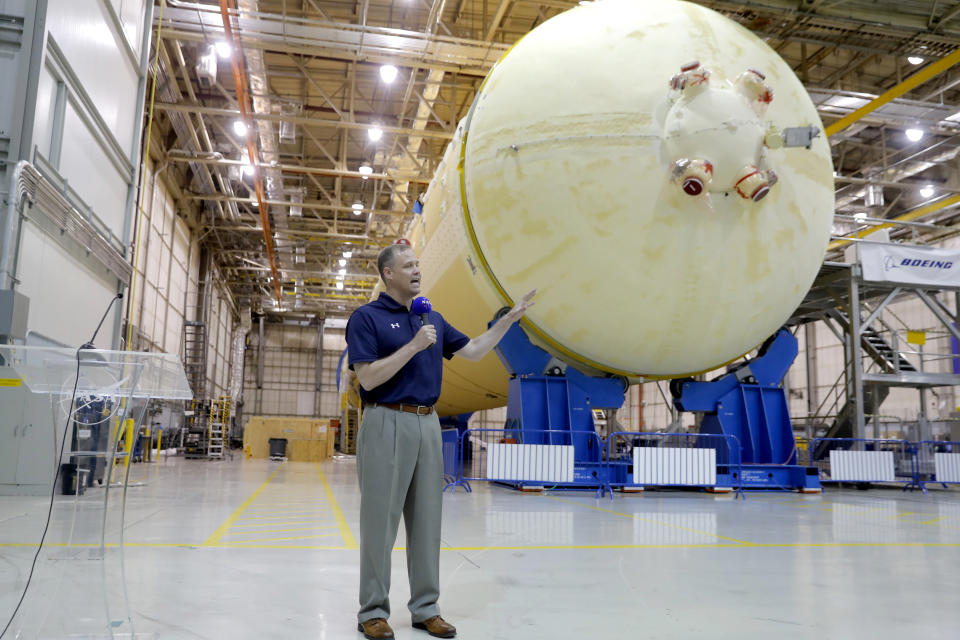 NASA Administrator Jim Bridenstine talks to reporters in front of the core stage of the Space Launch System, which will power the Artemis 1 lunar mission, as he visits the NASA Michaud Assembly Facility in New Orleans, Thursday, Aug. 15, 2019. (AP Photo/Gerald Herbert)