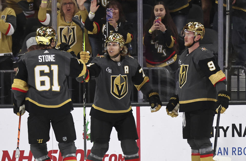 Vegas Golden Knights center William Karlsson, center, is congratulated by right wing Mark Stone (61) and center Jack Eichel (9) after scoring during the third period of an NHL hockey game against the Ottawa Senators, Sunday, Dec. 17, 2023, in Las Vegas. (AP Photo/Steve Marcus)