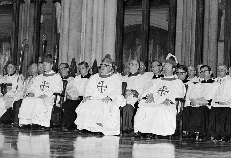 FILE - In this June 29, 1977 file photo, three newly-ordained Roman Catholic Bishops are seated among others participating in their ordination ceremonies in New York's St. Patrick's Cathedral. The bishops are, from left, Theodore E. McCarrick, Austin B. Vaughn, and Francisco Garmendia. All three bishops are Spanish speakers and were chosen in consideration of the growing Hispanic population of New York City and the suburbs. (AP Photo/Marty Lederhandler, File)