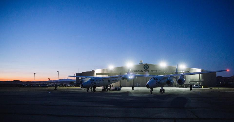 Virgin Galactic's WhiteKnightTwo, the mothership that cradles SpaceShipTwo under its wings, gets checked out before another dawn test flight. WK2 takes SS2 up to 50,000 feet, then drops it. The rocket fires on SS2, and carries the craft straight up for 60 seconds, eventually reaching space at 50 miles high.