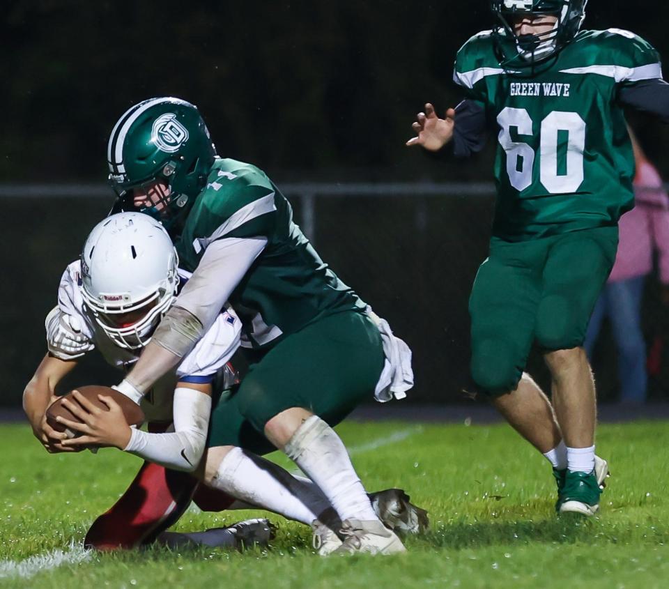 Dover's Bryce Carberry sacks Memorial quarterback Brady Harrison during Friday's Division I football game.