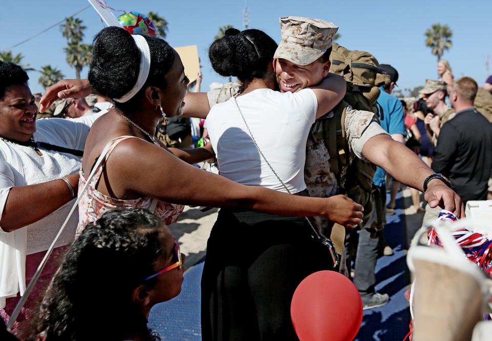 Sgt. Obie Dubose gets hugs from his family during a homecoming for Marines from the 13th MEU on April 24, 2014, in Camp Pendleton, California.