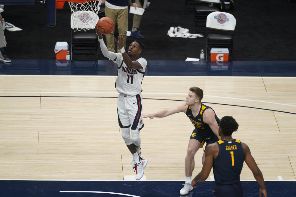 Gonzaga's Joel Ayayi (11) shoots as West Virginia's Sean McNeil (22) watches during the second half of an NCAA college basketball game Wednesday, Dec. 2, 2020, in Indianapolis. (AP Photo/Darron Cummings)