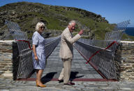 The Prince of Wales and the Duchess of Cornwall after a ribbon cutting ceremony at the new Tintagel bridge during a visit to Tintagel Castle while on a three day visit to Cornwall.