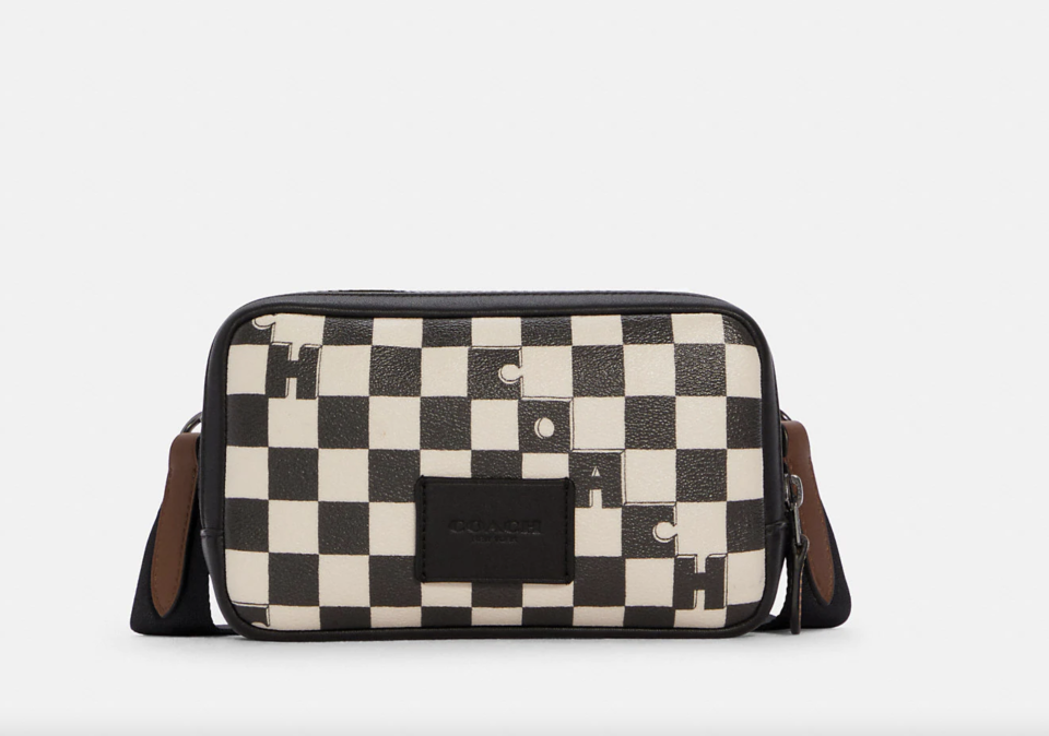 black and white checkered Carrier Phone Crossbody (Photo via Coach Outlet)