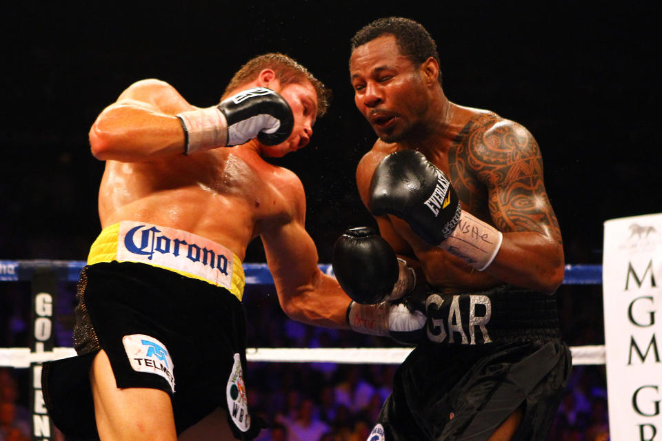 Canelo Alvarez hits Shane Mosley with a body shot.