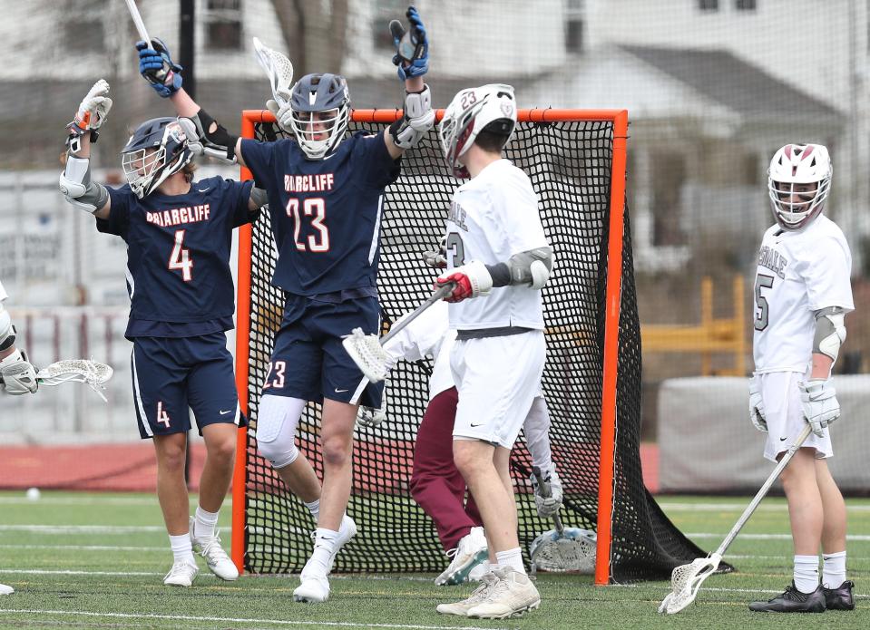 Briarcliff's Lucas Proctor (23) and Jack Ricciardi (4) celebrate a first half goal by Proctor against Scarsdale during boys lacrosse action at Scarsdale High School March 26, 2022. Briarcliff won the game 15-4.