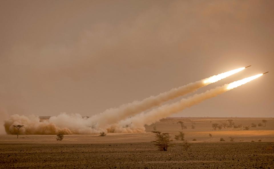 In this file photo taken on June 09, 2021 US M142 High Mobility Artillery Rocket System (HIMARS) launchers fire salvoes during the "African Lion" military exercise in the Grier Labouihi region in southeastern Morocco.