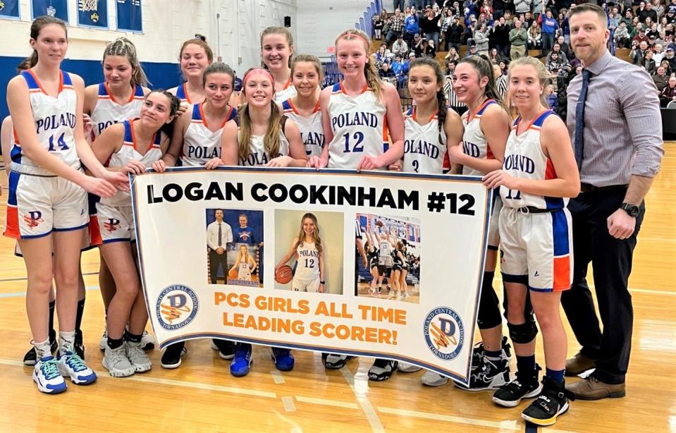 Logan Cookinham (12) was presented with a banner during a timeout after she broke Poland's career scoring record two minutes into the thurd quarter of a Section III playoff game against Copenhagen Saturday. She scored her 1,000th point in last year's sectional semifinal win.