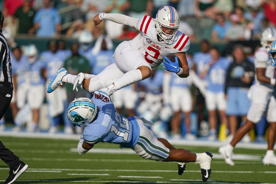 Mississippi quarterback Jaxson Dart (2) carries for a first down over Tulane defensive back DJ Douglas (12) in the second half of an NCAA college football game in New Orleans, Saturday, Sept. 9, 2023. Mississippi won 37-20. (AP Photo/Gerald Herbert)