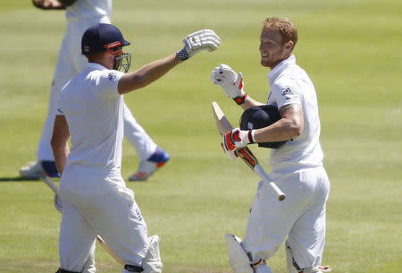 England's Ben Stokes (right) celebrates scoring a century with Jonny Bairstow during the second cricket test match against South Africa in Cape Town, South Africa, January 3, 2016. REUTERS/Mike Hutchings