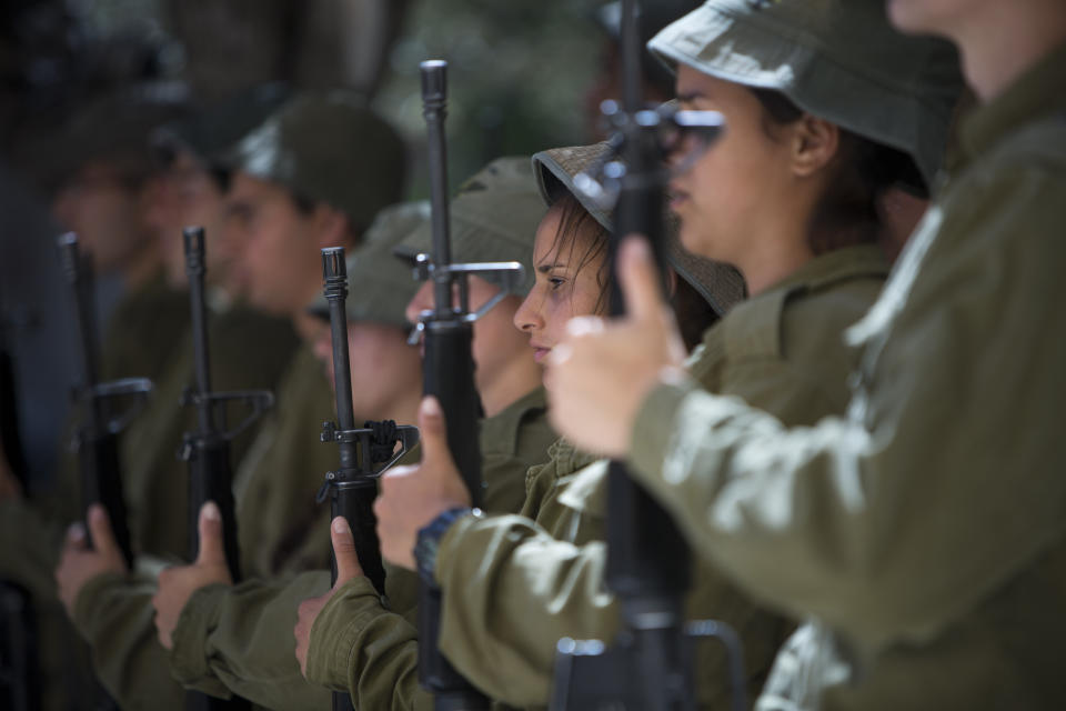 Israeli soldier honor guard conduct a rehearsal for the Memorial Day ceremony at Kiryat Shaul Military cemetery in Tel Aviv, Israel, Sunday, May 4, 2014. Israel will mark the annual Memorial Day in remembrance of soldiers who died in the nation's conflicts, beginning at dusk Sunday until Monday evening. (AP Photo/Oded Balilty)