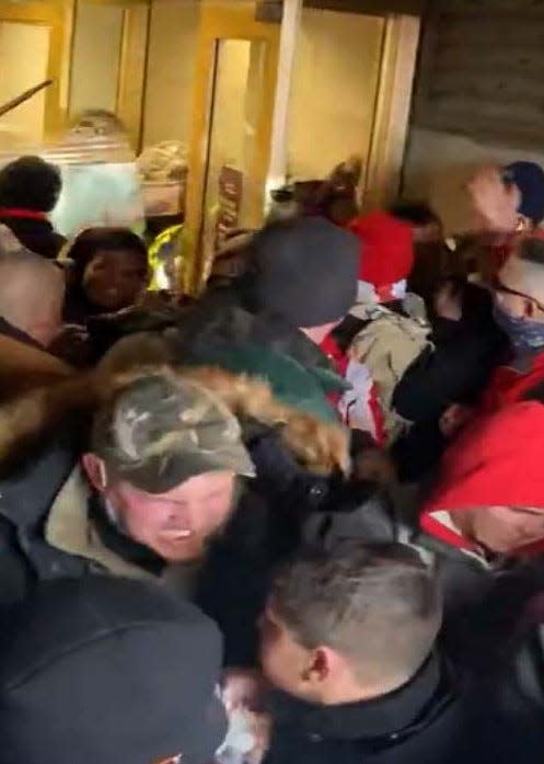 Ezekiel Stecher, in the camouflage hat, is among those arrested and charged with participating in the Capitol riot.