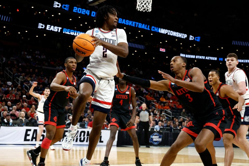 Connecticut Huskies guard Tristen Newton (2) makes a pass against the San Diego State Aztecs in the semifinals of the East Regional of the 2024 NCAA Tournament at TD Garden.