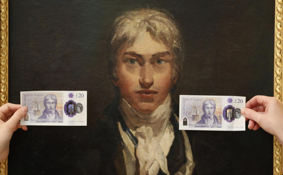 New 20 pound notes are displayed in front of a self portrait of JMW Turner during a photo opportunity at the Tate Britain in London, Thursday, Feb. 20, 2020. The new 20 pound note featuring the artist JMW Turner enters circulation on Feb. 20. (AP Photo/Frank Augstein)