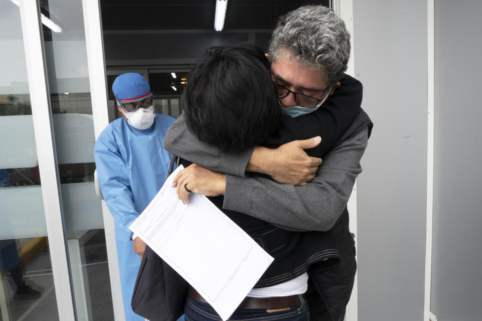 Sergio del Rio, 56, embraces his wife after he recovered and was released from the Ajusco Medio General Hospital which is designated for COVID-19 cases only, in Mexico City, Tuesday, Aug. 31, 2021. (AP Photo/Marco Ugarte)