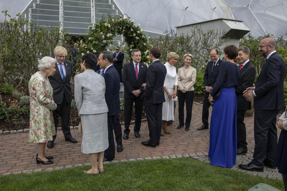 Britain's Queen Elizabeth II, left, speaks to Japanese Prime Minister Yoshihide Suga, at a reception for the G7 leaders at the Eden Project in Cornwall, England, Friday June 11, 2021, during the G7 summit. (Jack Hill/Pool via AP)