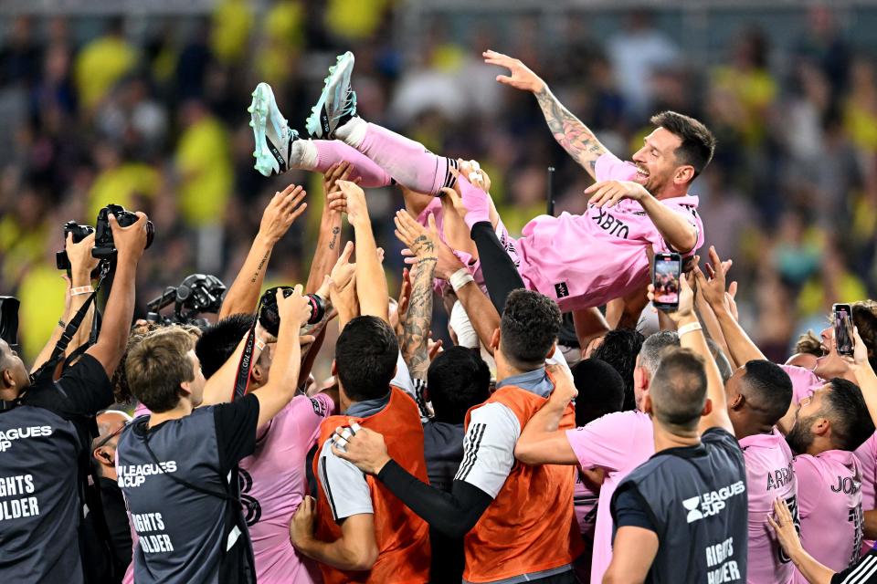 Inter Miami players hold up teammate Lionel Messi as they celebrate after winning the the Leagues Cup title with a win over Nashville SC on Saturday in Nashville, Tennessee. (CHANDAN KHANNA/AFP via Getty Images)