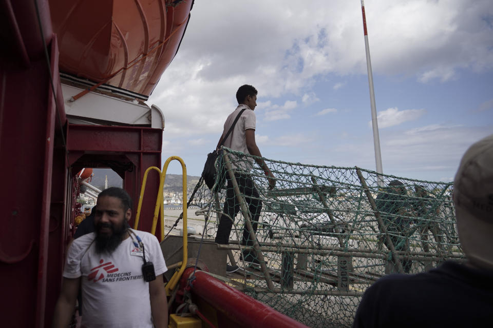 A migrant walks off the Ocean Viking ship docked at the port of Messina, Italy, Tuesday, Sept. 24, 2019. He was among 182 people aboard the Ocean Viking rescued in the Mediterranean Sea north of Libya. (AP Photo/Renata Brito)